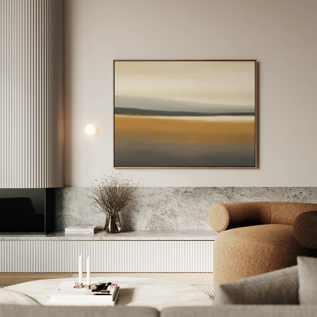 A modern living room with neutral tones features the large Honey Mesa Canvas Art, a round brown armchair, a marble shelf, a vase with dried branches, and soft ambient lighting—perfect for fans of modern decor.