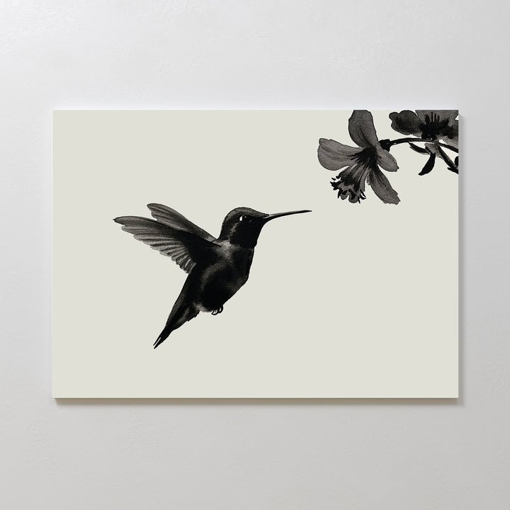 Hummingbird Motion Canvas Art: A minimalist black hummingbird print on a light background shows the bird mid-flight near a flower—ideal for sleek, modern decor.