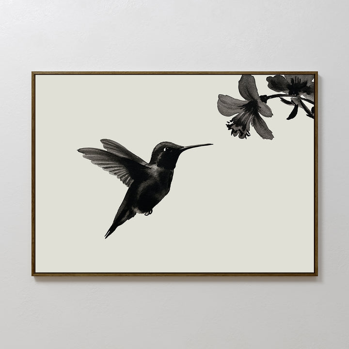 Hummingbird Motion Canvas Art features a sleek black hummingbird hovering near a flower on a light background, set in a thin brown frame—ideal minimalist wall decor for modern spaces.