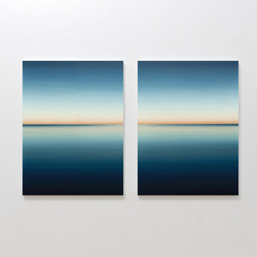 The Indigo Passage Set of 2 features square paintings with calm blue seascapes and soft orange horizons, creating serene minimalist wall art ideal for modern living room decor.