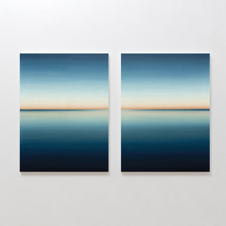 The Indigo Passage Set of 2 features square paintings with calm blue seascapes and soft orange horizons, creating serene minimalist wall art ideal for modern living room decor.