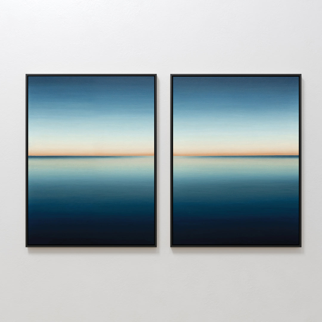 The Indigo Passage Set of 2 features framed paintings of a serene blue seascape with a clear horizon, hung side by side. This minimalist wall art adds tranquility and is ideal for enhancing modern living room decor.