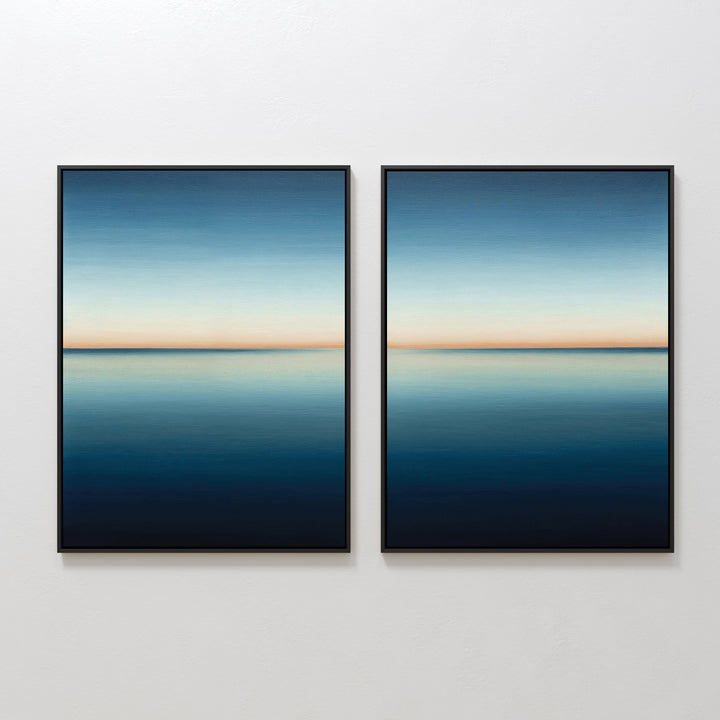 The Indigo Passage Set of 2 features framed paintings of a serene blue seascape with a clear horizon, hung side by side. This minimalist wall art adds tranquility and is ideal for enhancing modern living room decor.