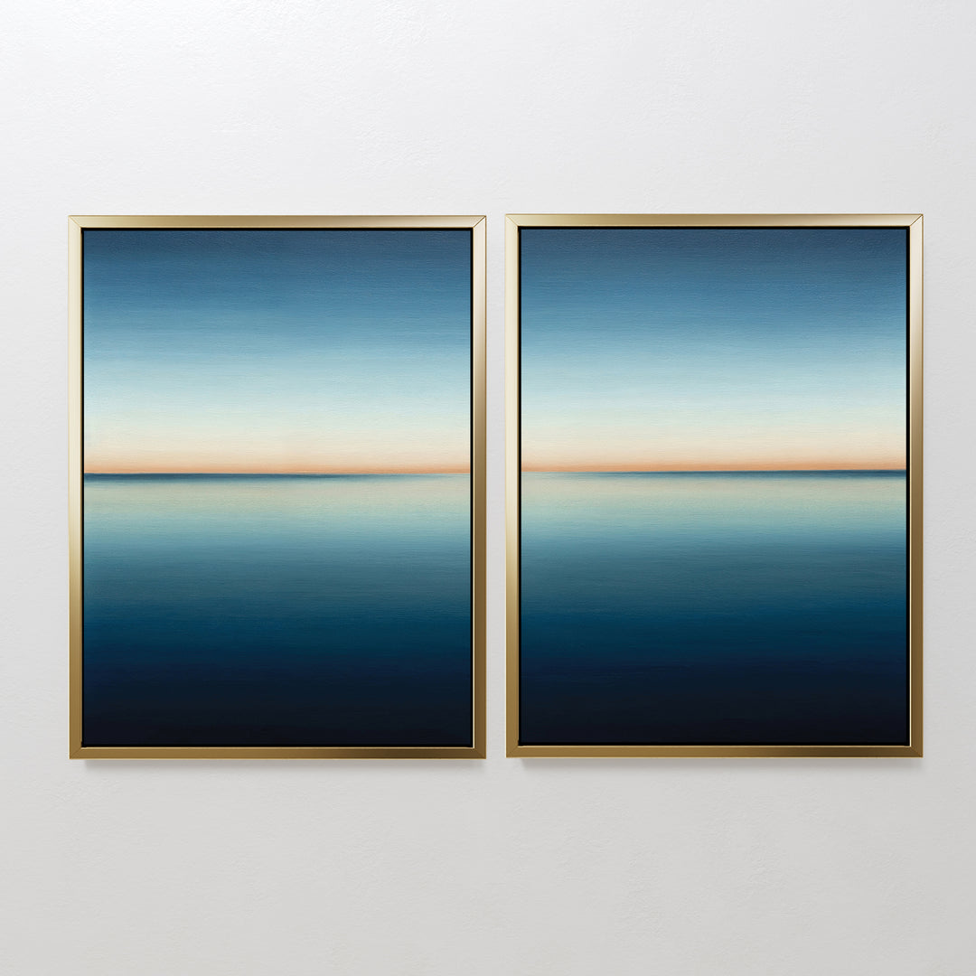 The Indigo Passage Set of 2 features framed abstract paintings with calm blue gradients and a thin orange horizon, creating serene, minimalist wall art perfect for modern living room decor.