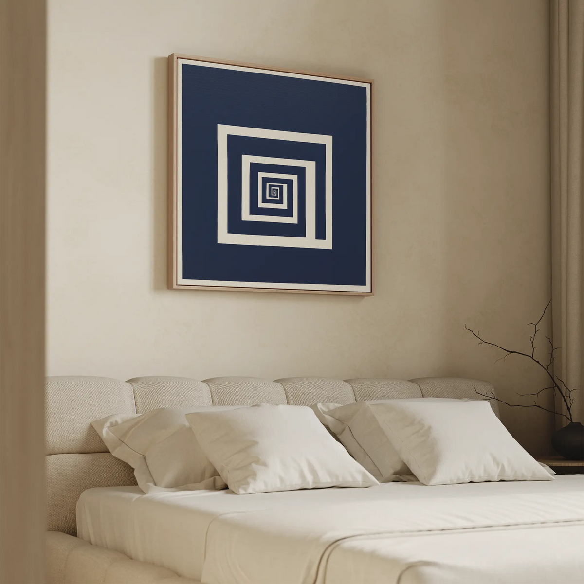 A modern bedroom with a beige upholstered bed, white pillows, and minimalist decor features the Infinite Descent Canvas Art above the bed—abstract wall art with concentric white squares on a dark blue background.