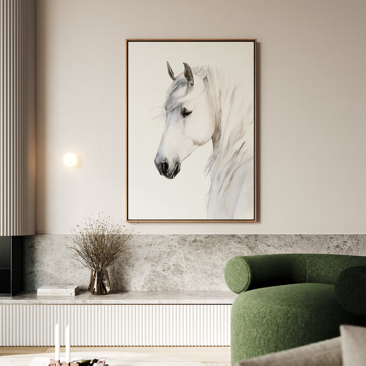 A modern living room with a green curved sofa, marble accents, a vase of dried branches, and the Ivory Mane Canvas Art—a striking white horse print with its head lowered—gracefully displayed on the wall.