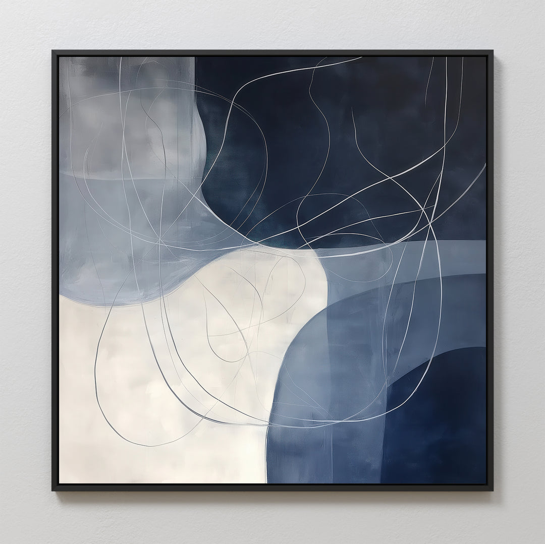 Midnight Lines Abstract Canvas Art features navy blue, white, and gray geometric shapes intersected by thin, curved white lines. Framed in black, this elegant piece is ideal for adding modern style to your living room walls.