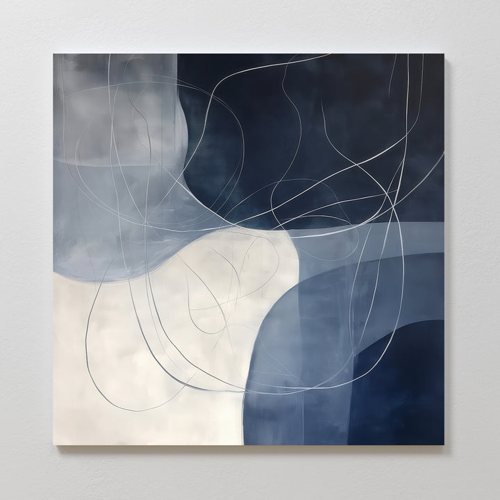 Midnight Lines Abstract Canvas Art features overlapping shapes in blue, navy, and white with thin curving lines for a fluid look—an elegant wall art piece ideal for adding modern style to your living room decor.
