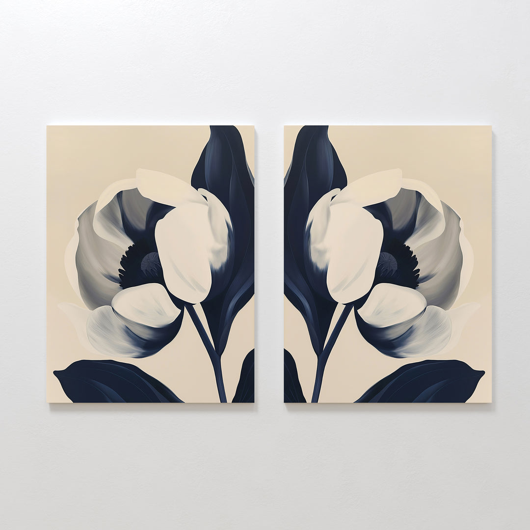The Midnight Tulip Set of 2 features minimalist canvas prints with abstract large flowers—white petals and dark blue leaves—creating stylish botanical wall art, ideal for modern living room decor.