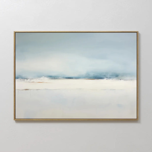 The Misty Morning Canvas Art – Horizontal features soft blue and white tones evoking a calm, foggy horizon. Framed in thin gold and displayed on a white wall, its perfect for coastal-inspired or minimalist decor.