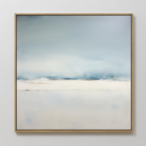 Misty Morning Abstract Canvas Art features soft blue and white tones in a minimalist landscape, evoking a serene sky over snowy ground. Framed in wood and hung on a white wall, it’s perfect for tranquil home decor.