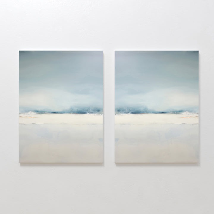 The Misty Morning Set of 2 features minimalist wall art in soft blue, white, and beige tones, hung side by side. Each piece evokes a tranquil mood with blurred horizontal landscapes reminiscent of a serene Nordic park.