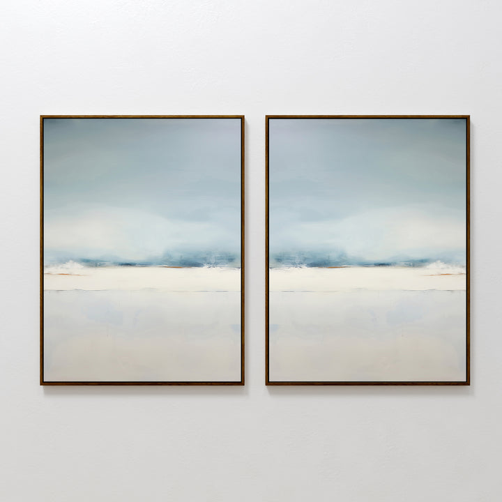 The Misty Morning Set of 2 features minimalist framed abstract paintings in soothing blue, white, and beige tones. Displayed side by side, they evoke the calm beauty of a Nordic park over water, creating a tranquil atmosphere in any space.