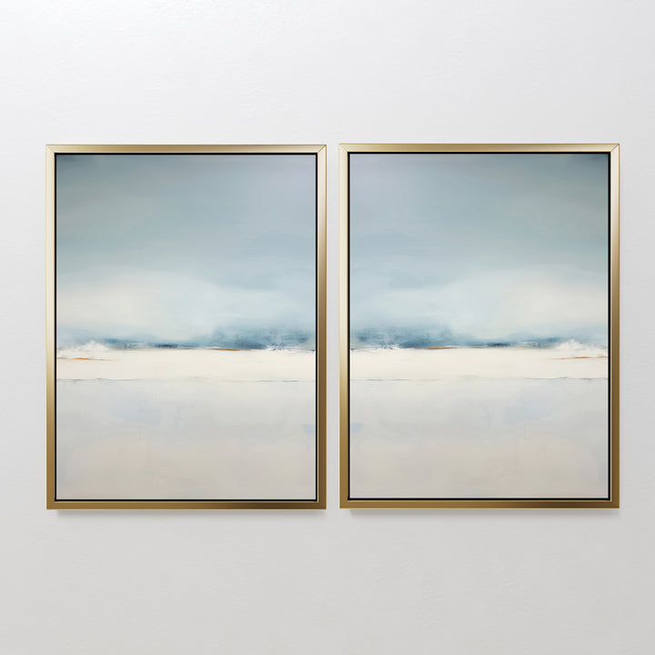 The Misty Morning Set of 2 features framed abstract art in soft blue, white, and beige tones. Their minimalist design with mirrored horizon lines evokes serene seascapes or landscapes, creating a tranquil atmosphere on any white wall.