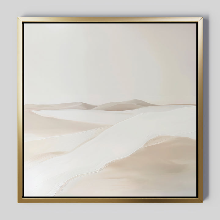 The Misty Vale Abstract Canvas Art features a minimalist painting of sand dunes in soft beige and white tones, framed with a thin gold border. Its smooth lines create a serene landscape—ideal wall art for bedrooms or living rooms.