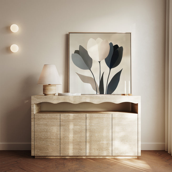A modern console table with a wavy-edge design displays a lamp, two candles, and the Muted Elegance Canvas Art. Beige walls and circular wall lights add to the elegant, contemporary vibe—ideal for modern bedroom decor.