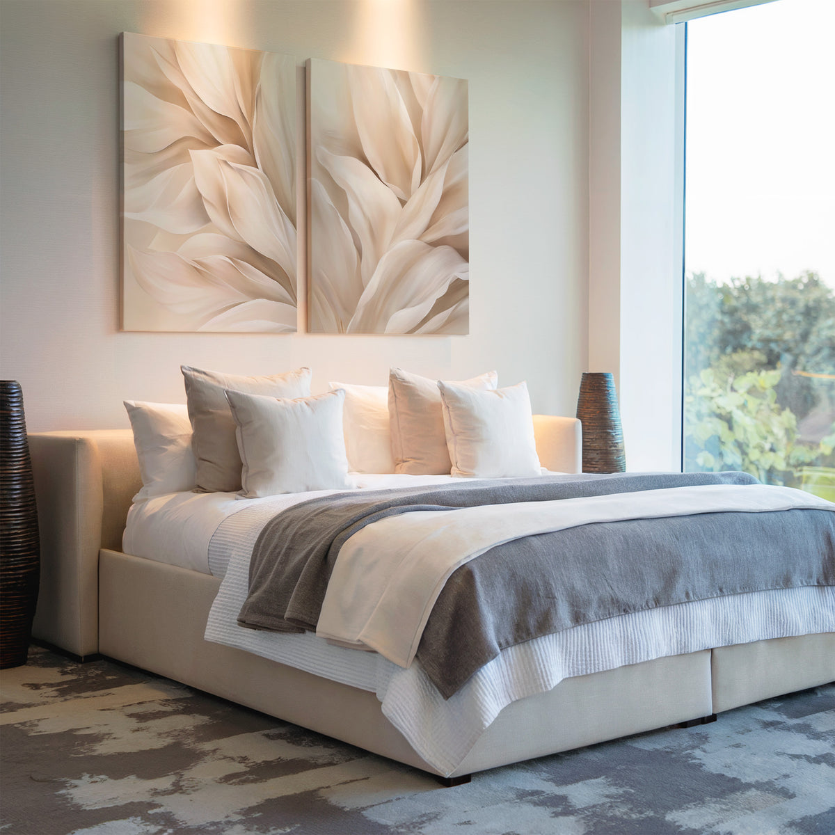 A modern bedroom with a large bed, white and gray bedding, multiple pillows, neutral wall art above the headboard, two Natural Texture Set of 2 vases on each side, and a large window letting in natural light.