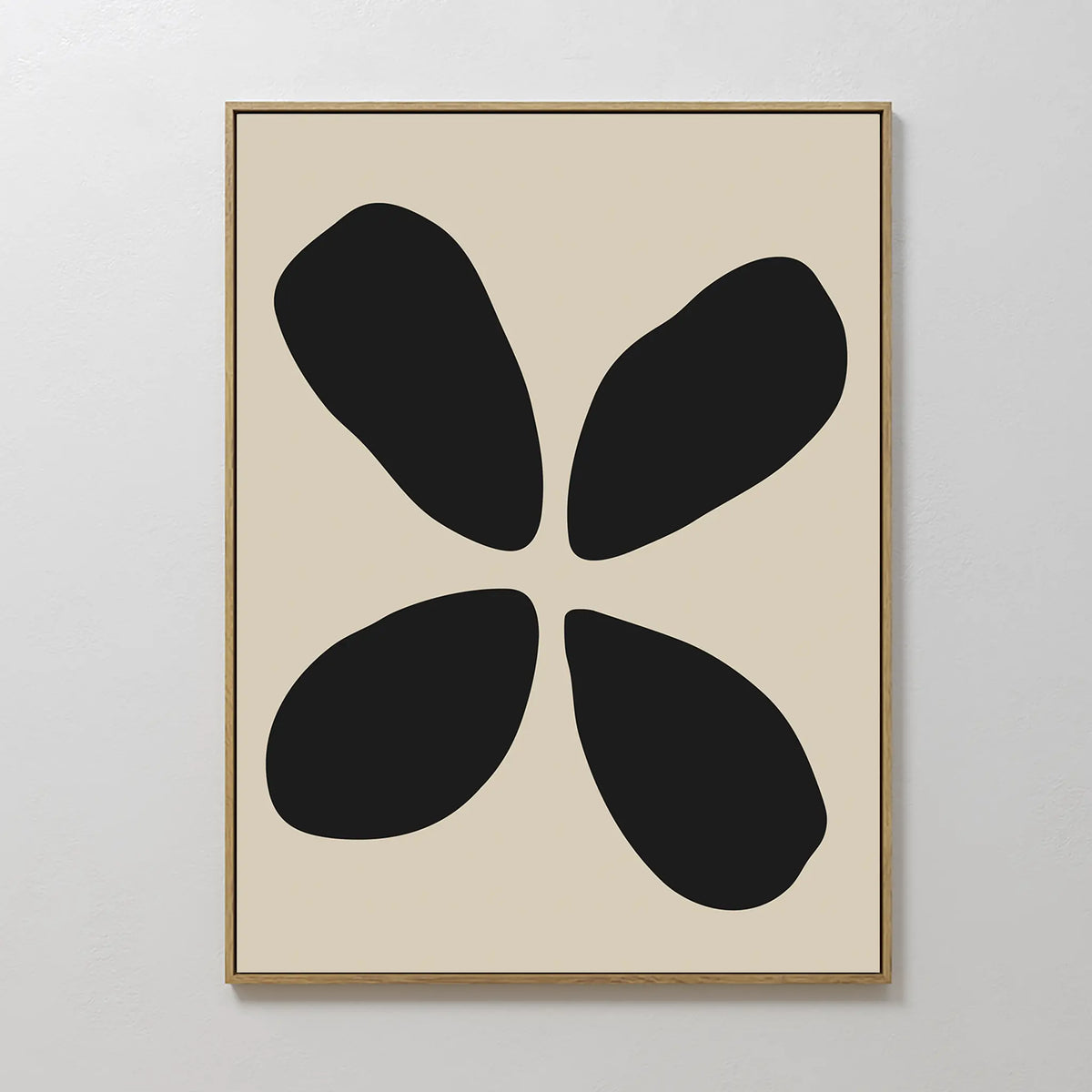Noir Botanica Canvas Art showcases four bold, uneven black ovals arranged symmetrically on a light beige background in a slim gold frame—an ideal choice for adding modern, minimalist style to your space.