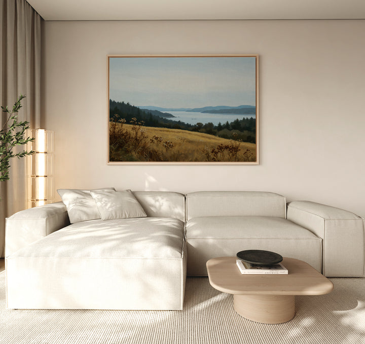 A modern living room featuring a light beige sectional sofa, low wooden coffee table, tall plant, and the Northern Silence Canvas Art as minimalist wall art on a neutral wall for an elegant decor touch.
