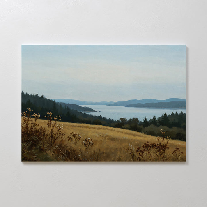 The Northern Silence Canvas Art showcases a grassy field with wildflowers, evergreen trees, and a calm lake beneath distant blue hills—ideal minimalist wall art for adding serenity to your living room decor.