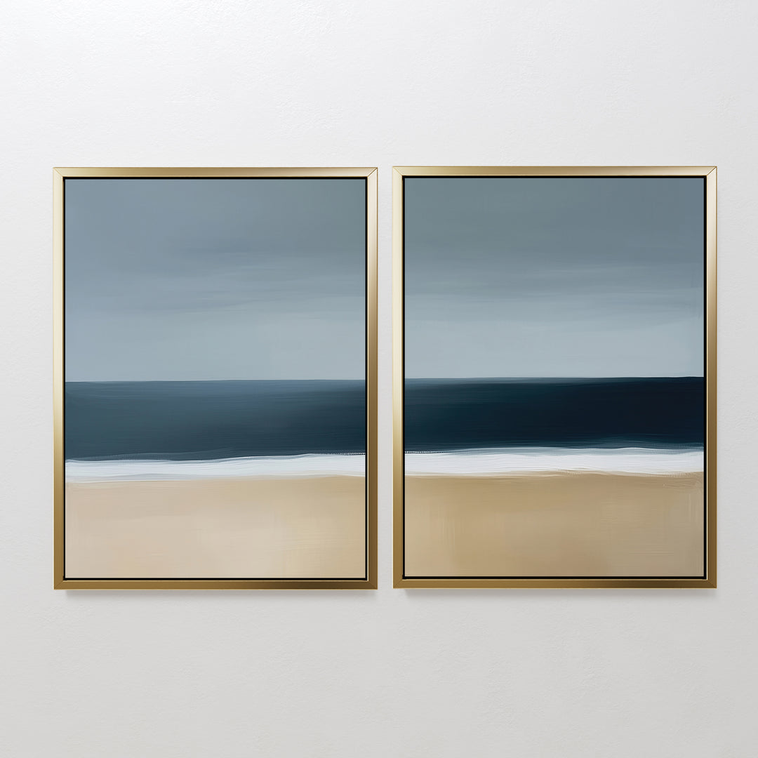 The Ocean Edge Set of 2 features framed abstract seascapes with blue sky, dark ocean, and beige sand—ideal minimalist wall art for a serene living room, showcasing soft lines and muted tones.