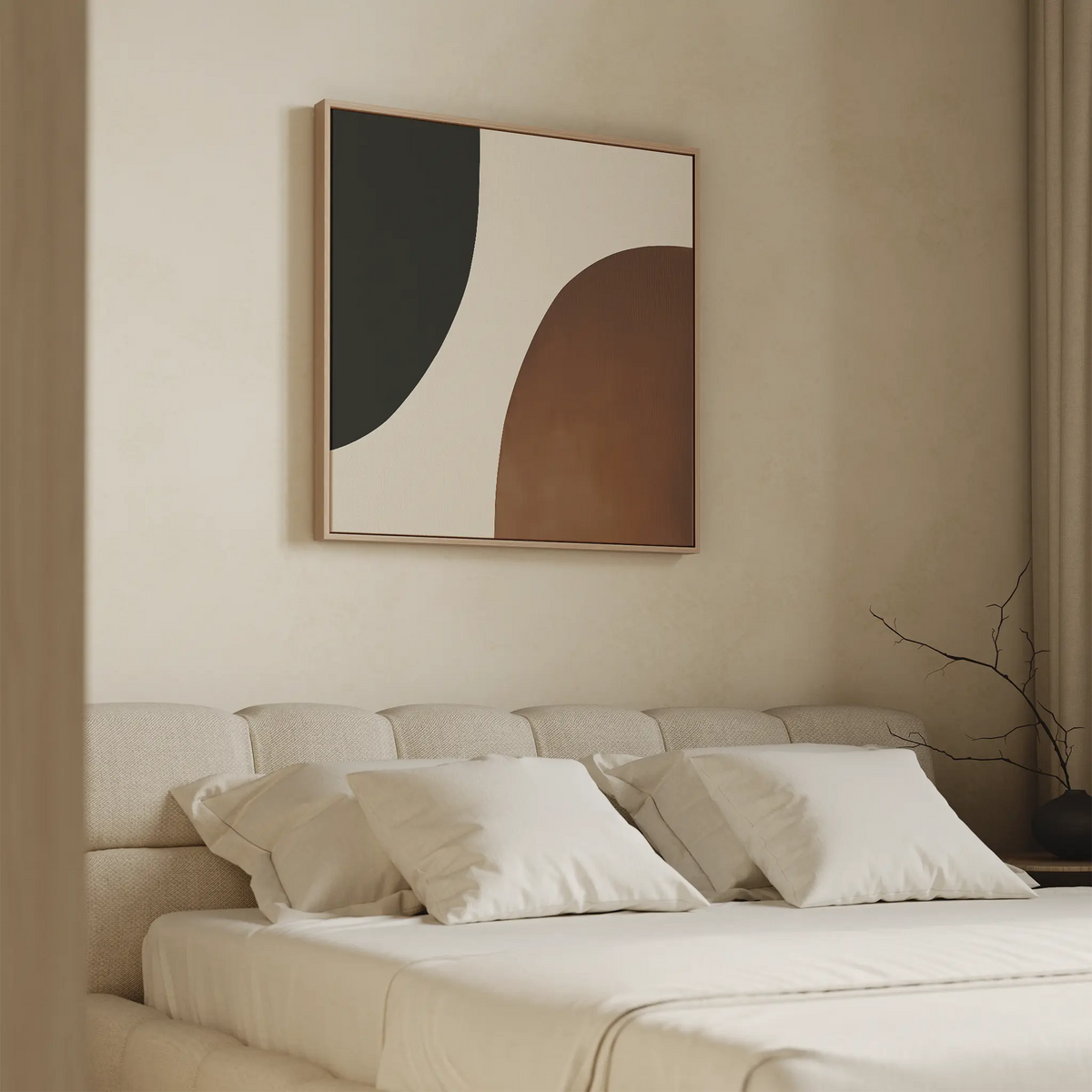 A modern bedroom with a beige upholstered bed, white bedding, and four pillows. Above the bed hangs the Organic Balance Canvas Art in black, white, and brown tones. A vase with bare twigs sits on the right side.