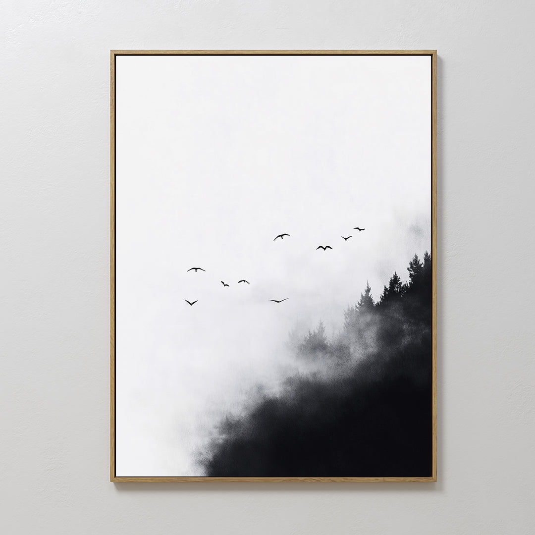 Passing Pines Canvas Art features black bird silhouettes soaring over misty pine trees on a white background, framed in gold. This minimalist wall art adds serenity and elegance to any space.