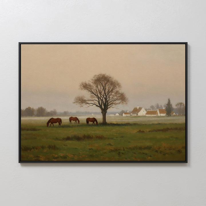 Pasture Morning Canvas Art: A framed wall print depicting three horses grazing on green grass near a large leafless tree, with misty houses in the background—ideal countryside decor.