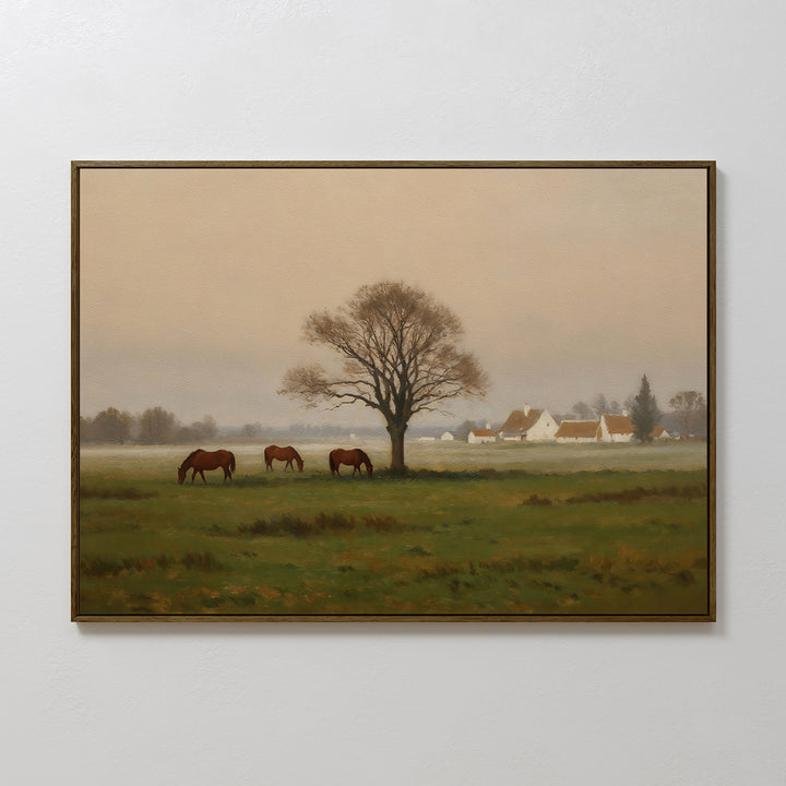 Pasture Morning Canvas Art features three horses grazing in a green field, a bare tree at the center, and a misty village with white houses and orange roofs—perfect countryside décor or wall art print.