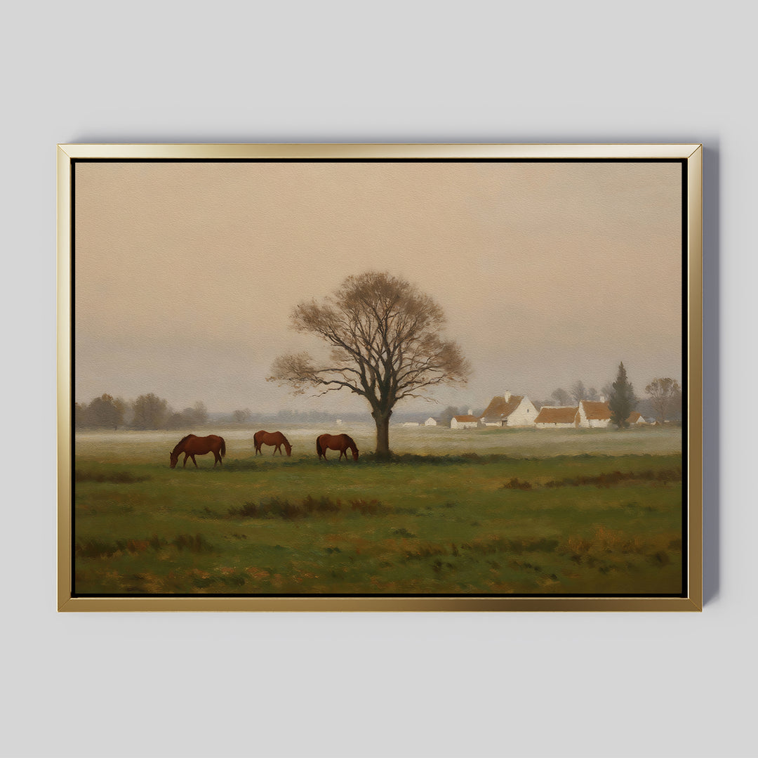 Bring tranquility to your space with the Pasture Morning Canvas Art, featuring three brown horses grazing in a green field near a large bare tree and white houses with red roofs under a serene, cloudy sky.