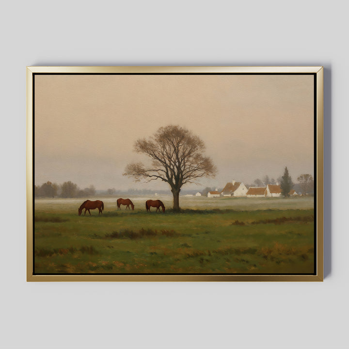 Bring tranquility to your space with the Pasture Morning Canvas Art, featuring three brown horses grazing in a green field near a large bare tree and white houses with red roofs under a serene, cloudy sky.