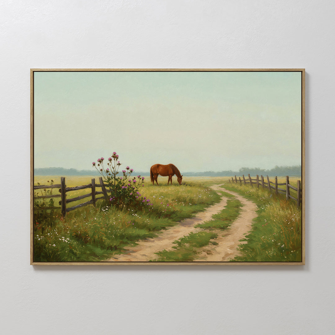The Pasture Path Canvas Art features a brown horse grazing in a grassy field by a winding dirt path, wildflowers, and a wooden fence, adding rustic charm to your wall decor under a pale blue sky.