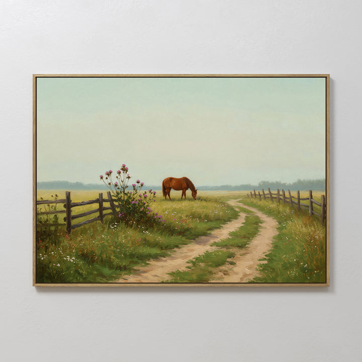 The Pasture Path Canvas Art features a brown horse grazing in a grassy field by a winding dirt path, wildflowers, and a wooden fence, adding rustic charm to your wall decor under a pale blue sky.