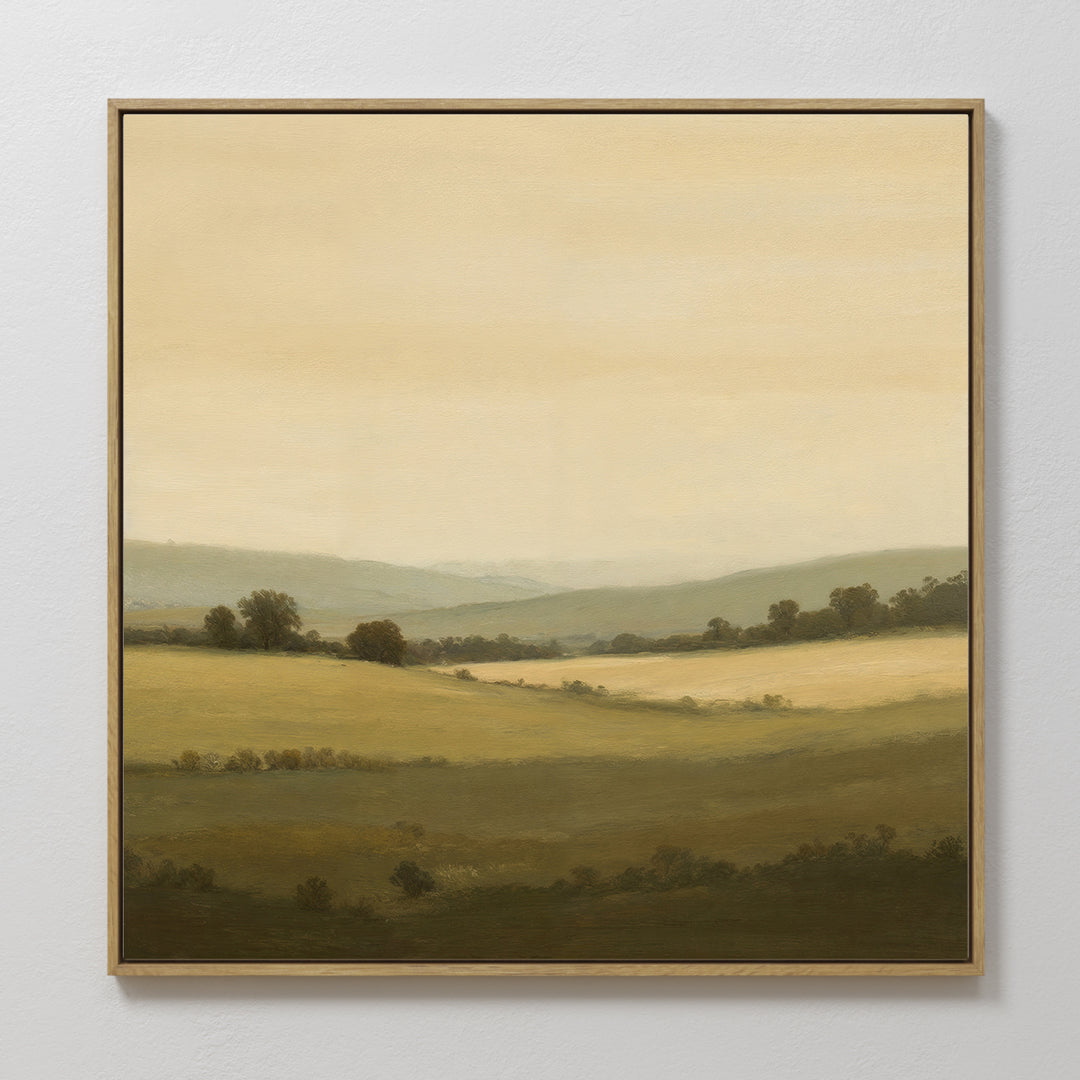 Quiet Countryside Canvas Art: A framed painting depicting rolling green hills, scattered trees, and a soft, hazy sky in warm tones. This serene rural landscape creates a peaceful and calming atmosphere for any room.
