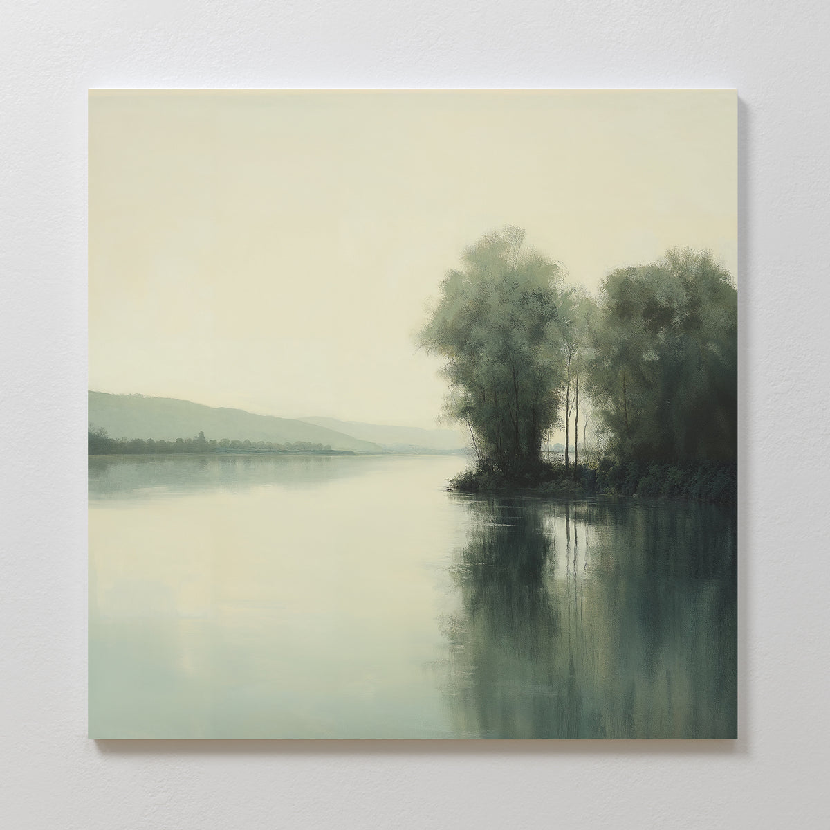 Reflective River Canvas Art features a calm river with trees on the right bank mirrored in still water, and misty hills fading into a pale sky—a serene decor piece for any space.