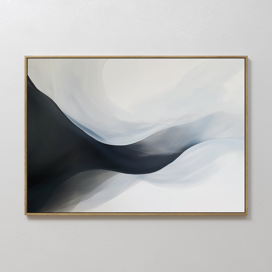 Rippling Vista Abstract Canvas Art features flowing black, gray, and white shapes for a modern, minimalist look. Framed with a thin gold edge and displayed on a light wall, it adds elegant movement to your decor.