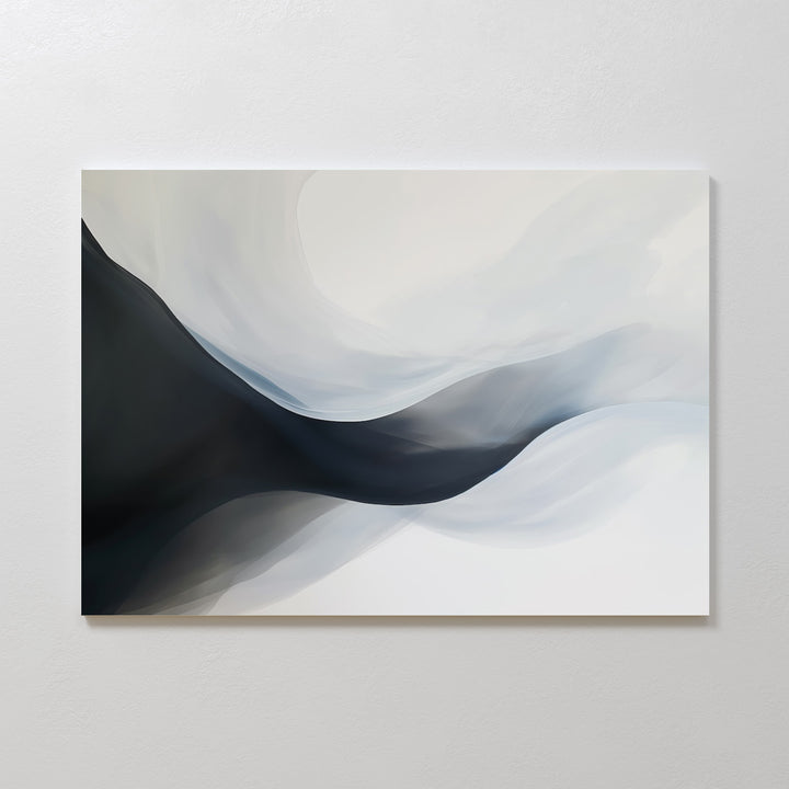 Rippling Vista Abstract Canvas Art features smooth, flowing shapes in black, gray, and white, creating a sense of movement and depth. This minimalist piece adds modern elegance to any space and looks stunning mounted on a pale wall.