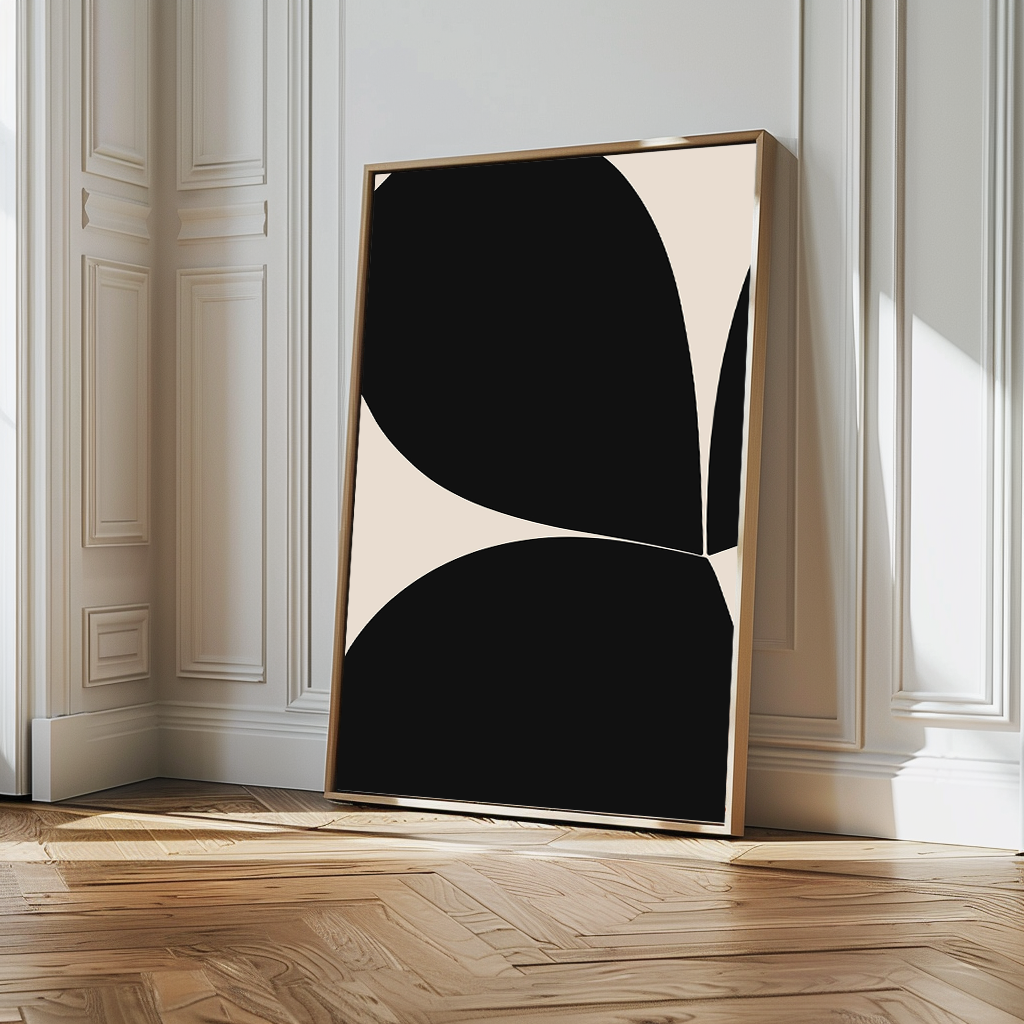 The Black Botanical Abstract Canvas Art, featuring bold black and white curves, rests against a white paneled wall on a wooden herringbone floor, enhancing the bright interior with a touch of contemporary sophistication.