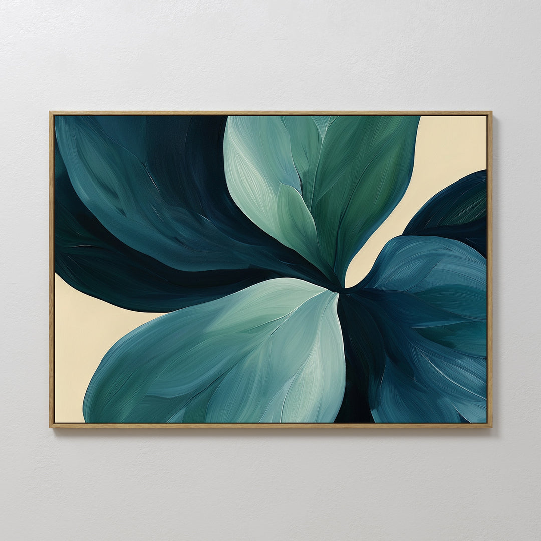 The Lush Teal Foliage Abstract Canvas Art features large blue and green leaves on a light beige background, making it perfect wall decor for your living room. Displayed framed on a white wall.