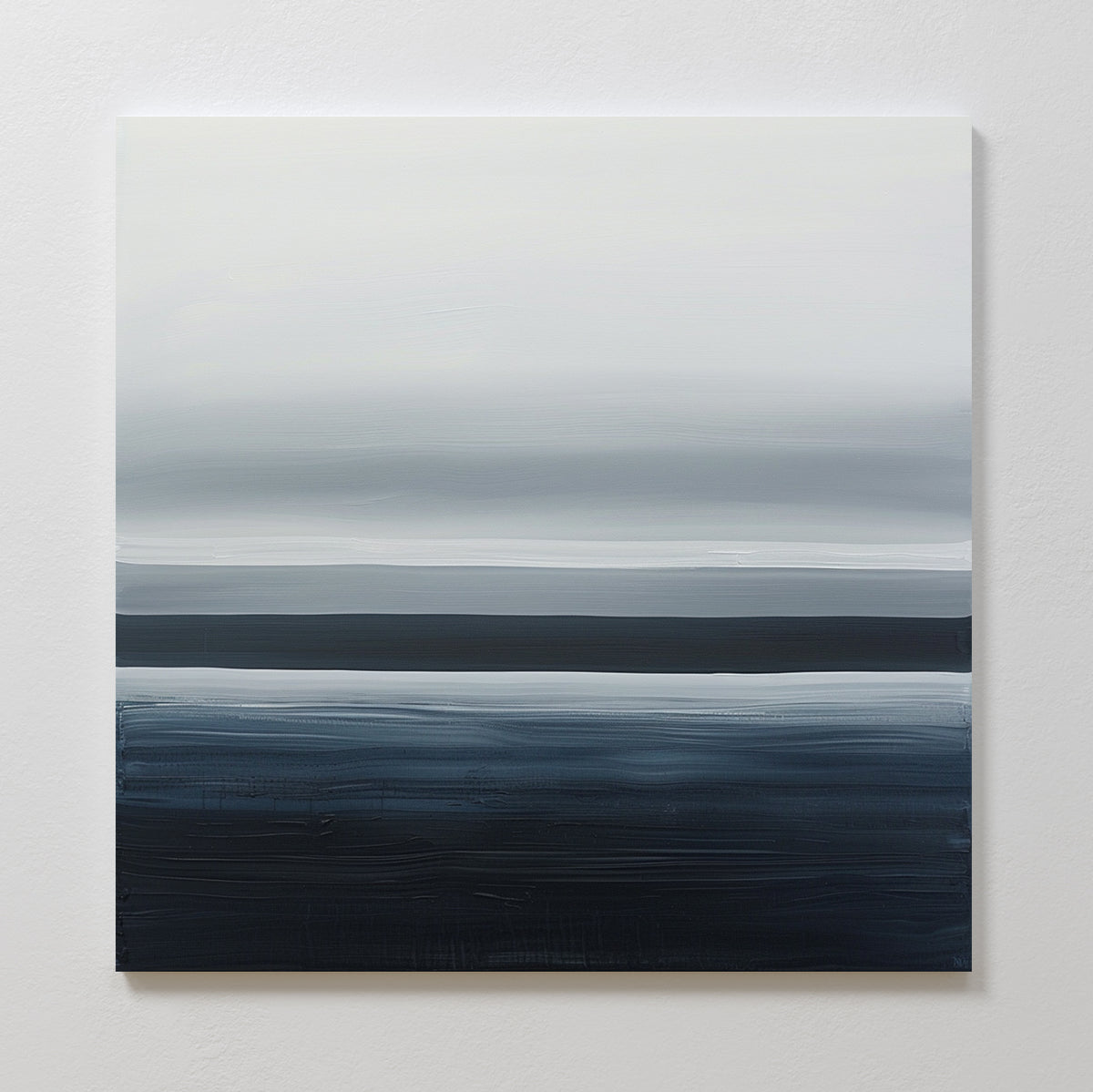 Oceanic Blur Abstract Canvas Art features horizontal bands of white, gray, and dark blue, creating a soft minimalist seascape—ideal coastal-inspired wall art for living room decor when mounted on a plain white wall.