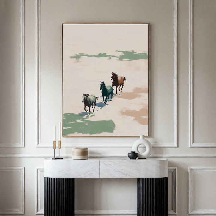 A modern living space featuring a marble console table, decorative objects, and the Running Free Canvas Art—a striking print of three horses running against a neutral background, ideal for minimalist décor enthusiasts.