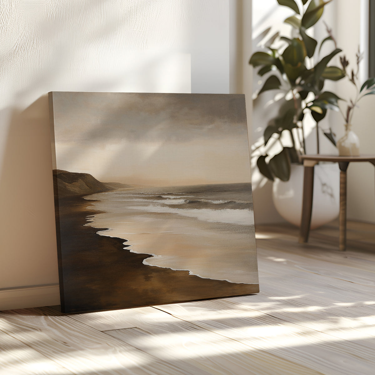 The Sandy Shoreline Canvas Art features waves rolling onto dark sand, adding a serene coastal touch to bright, airy living rooms—perfect wall decor for beach lovers.