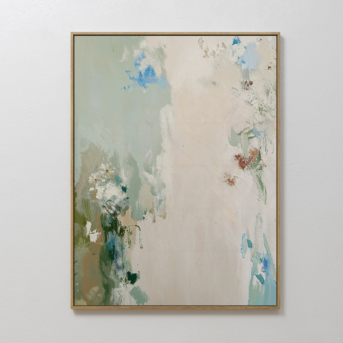 Serenity Garden Abstract Canvas Art showcases soft, blended shades of green, blue, beige, and white with textured brushstrokes. Elegantly framed, this modern piece adds a vivid yet serene touch when displayed on a plain white wall.