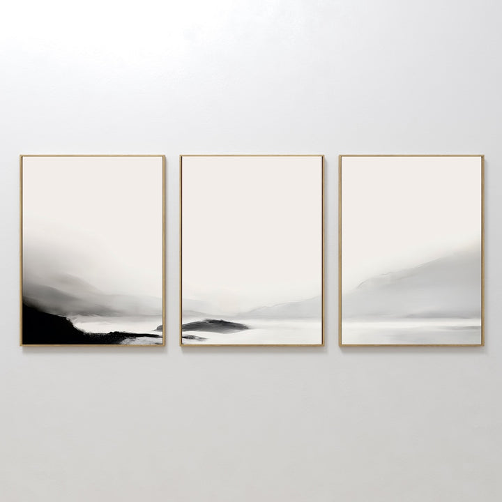 The Serenity Peaks Set of 3 is a minimalist triptych with soft, muted gradients of white, gray, and black. This abstract landscape evokes misty mountains or foggy hills for a serene, elegant touch to your home decor.