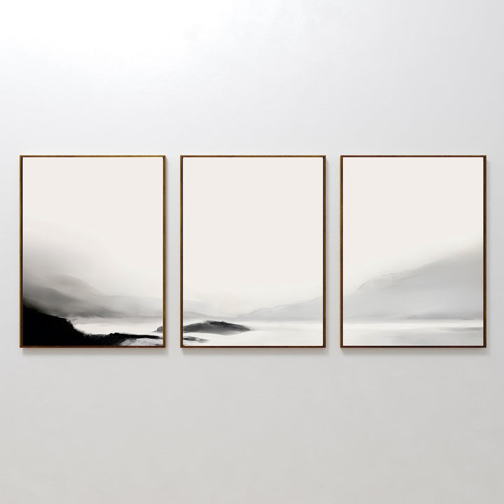 The Serenity Peaks Set of 3 features minimalist framed abstract mountain prints in black, white, and gray, displayed side by side on a plain white wall—ideal for modern décor.