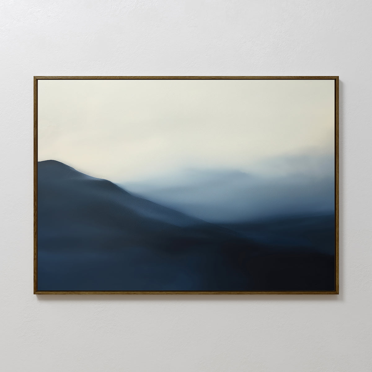 The Shadowed Valley Canvas Art – Horizontal features misty blue mountains beneath a pale, cloudy sky, with soft blue, gray, and white gradients. Its thin dark frame makes it perfect as calming bedroom decor.