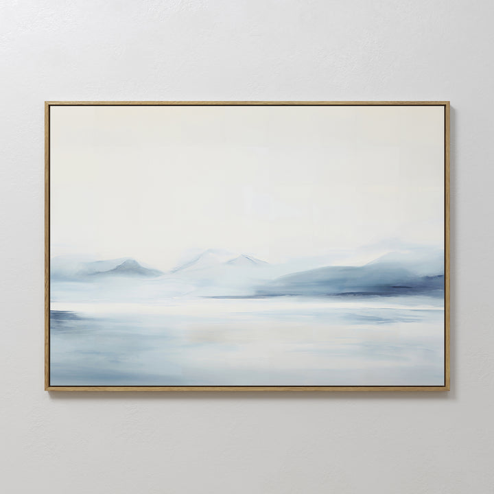 Silent Glaciers Canvas Art is a large framed abstract painting featuring misty blue and white tones that evoke distant mountains, adding minimalist serenity to any room.