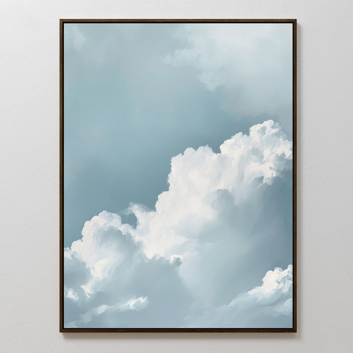 Sky Serenade Abstract Canvas Art features fluffy white clouds on a soft blue sky, framed and displayed on a plain white wall—minimalist wall art that brings calming, serene vibes to any living room decor.