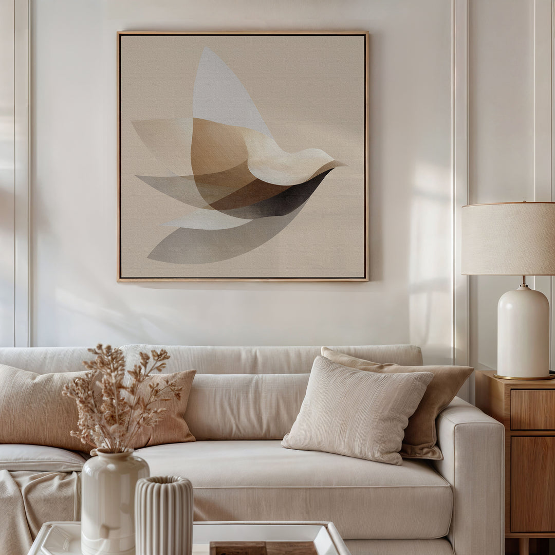 A modern living room features a light beige sofa with cream cushions, a beige lamp on a wooden side table, and the Soaring Stillness Canvas Art with abstract neutral tones hanging above the sofa.