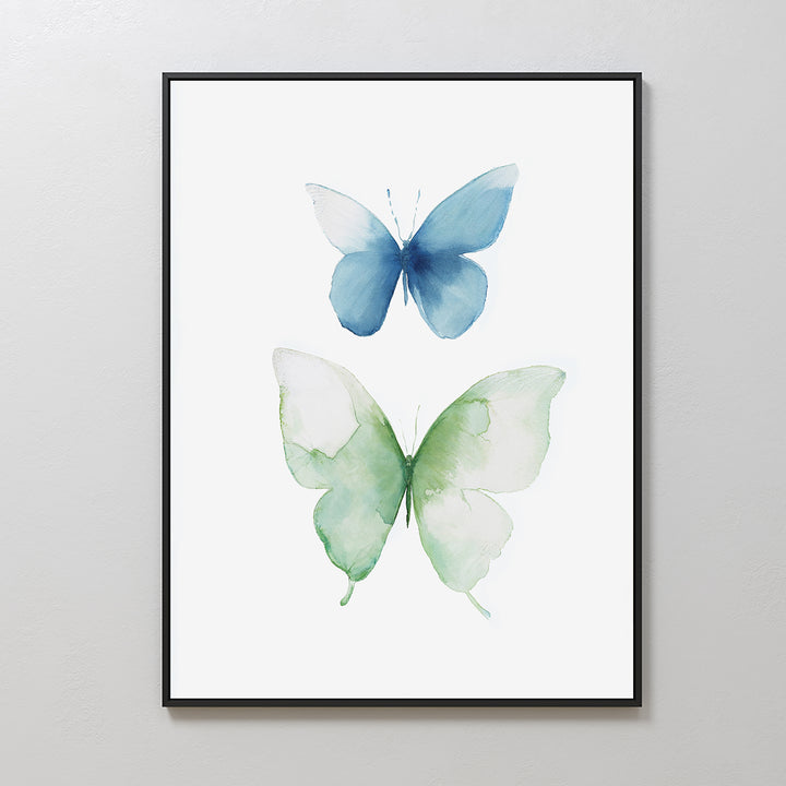 Soft Flight Canvas Art: A minimalist framed artwork showcasing two watercolor butterflies, one blue and one green, on a white background—Nordic Park-inspired elegance for your wall.